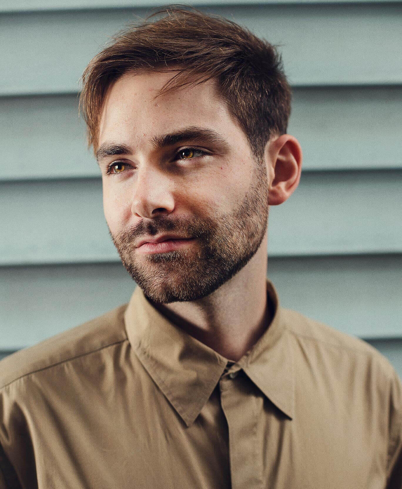Charles McDonald headshot in front of blue background.